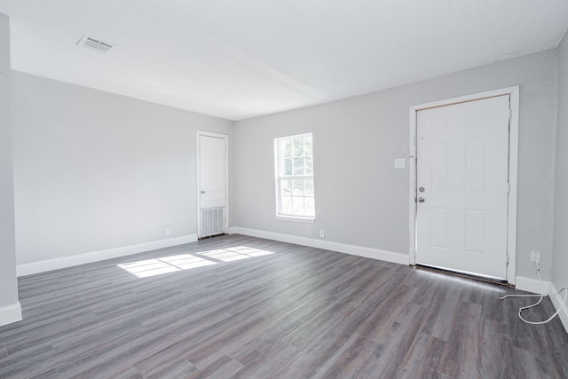 spare room featuring dark hardwood / wood-style flooring