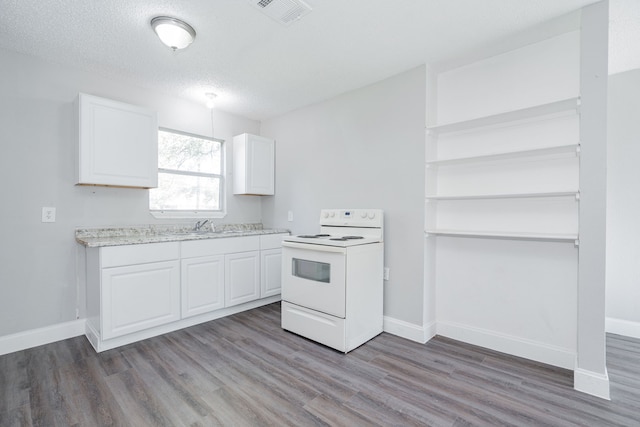 kitchen with hardwood / wood-style floors, white electric range, sink, a textured ceiling, and white cabinetry