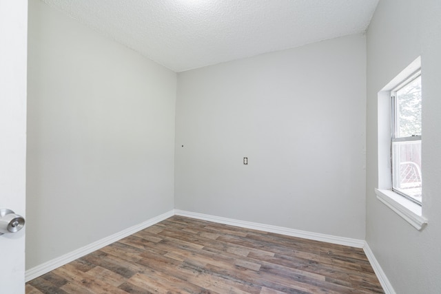 unfurnished room featuring a textured ceiling and hardwood / wood-style flooring