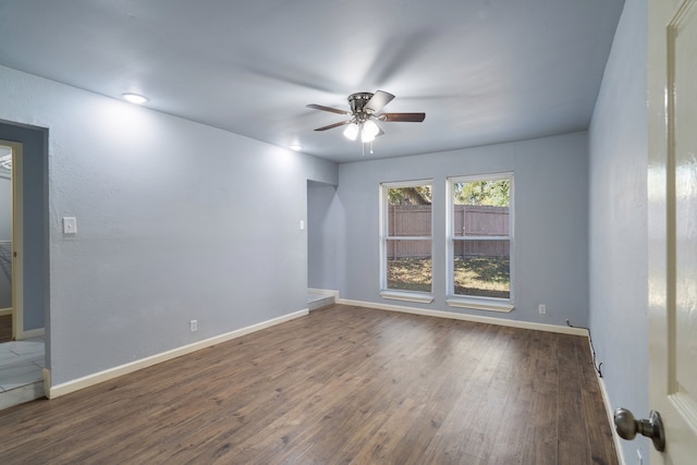 unfurnished room with dark hardwood / wood-style floors and ceiling fan