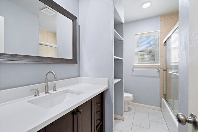 full bathroom featuring shower / bath combination with glass door, vanity, and toilet