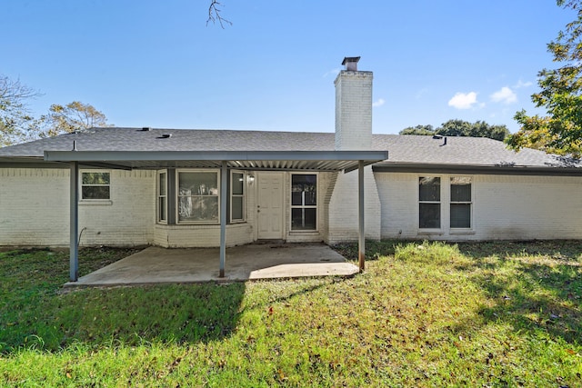 back of property featuring a yard and a patio