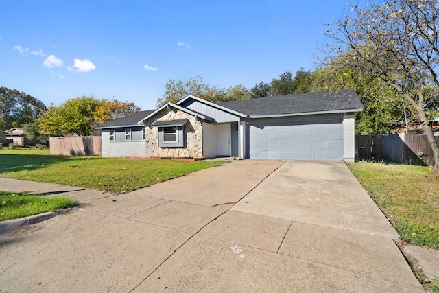 single story home with a garage and a front lawn