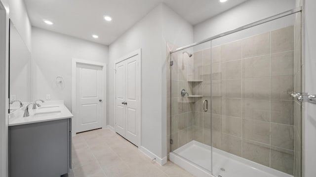 bathroom with walk in shower, tile patterned floors, and vanity