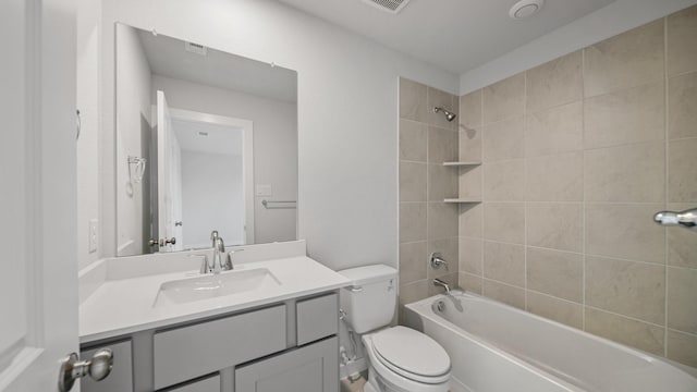 full bathroom with vanity, toilet, and tiled shower / bath combo