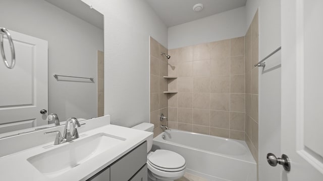 full bathroom with vanity, tiled shower / bath combo, and toilet