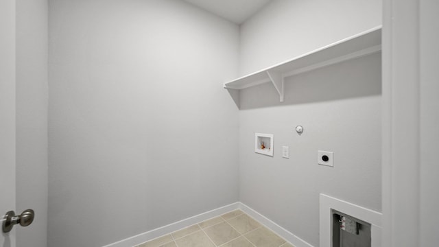 washroom featuring hookup for a gas dryer, light tile patterned flooring, washer hookup, and hookup for an electric dryer