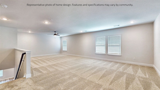 carpeted empty room featuring ceiling fan and a textured ceiling