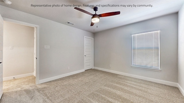 unfurnished room with ceiling fan and light colored carpet