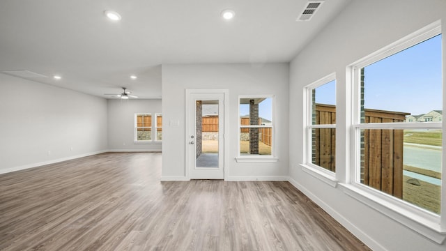 unfurnished living room with hardwood / wood-style flooring and ceiling fan