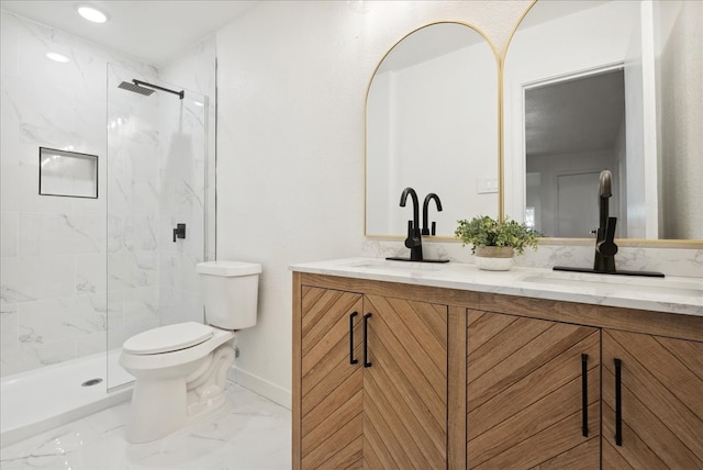 bathroom featuring vanity, toilet, and a shower with door