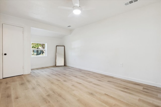 unfurnished room with light wood-type flooring and ceiling fan