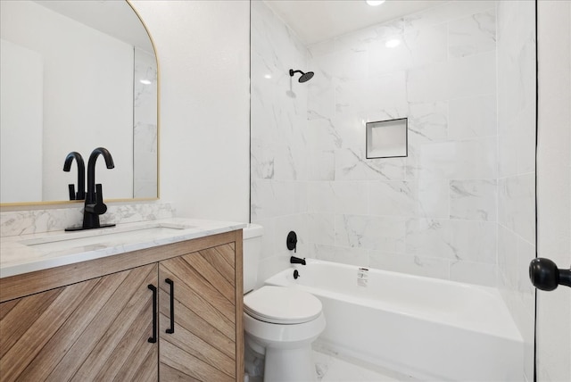 full bathroom with vanity, toilet, and tiled shower / bath