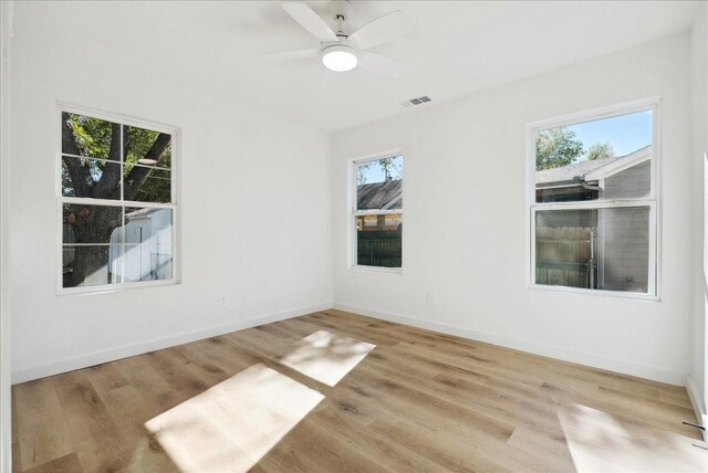 empty room featuring ceiling fan and light hardwood / wood-style floors