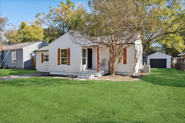 view of front of home featuring a front lawn, an outdoor structure, and a garage