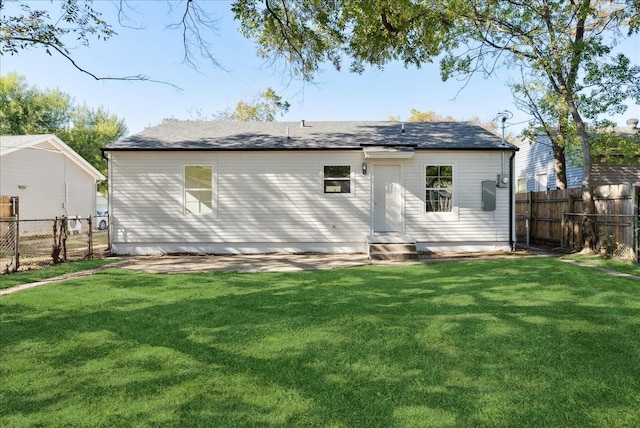 rear view of property with a lawn