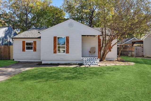 rear view of house with a lawn