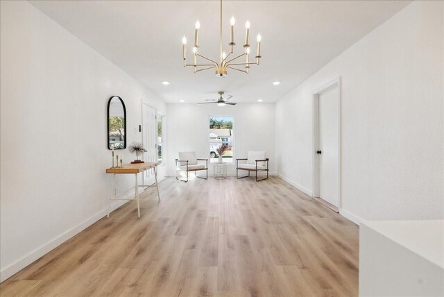 interior space with light hardwood / wood-style flooring and ceiling fan with notable chandelier