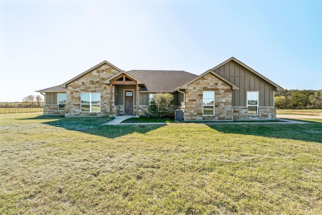 craftsman-style house featuring a front lawn and central AC unit