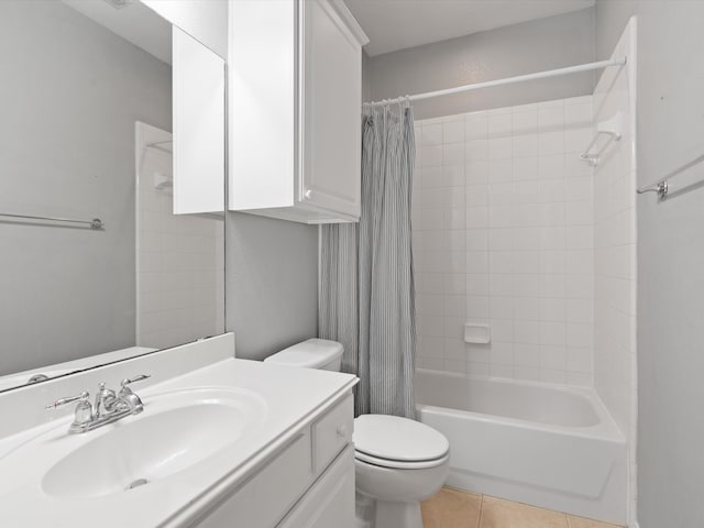 full bathroom featuring tile patterned floors, shower / bath combo with shower curtain, vanity, and toilet