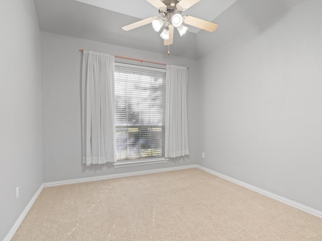 carpeted empty room with vaulted ceiling and ceiling fan