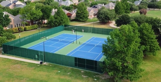 view of sport court featuring a yard