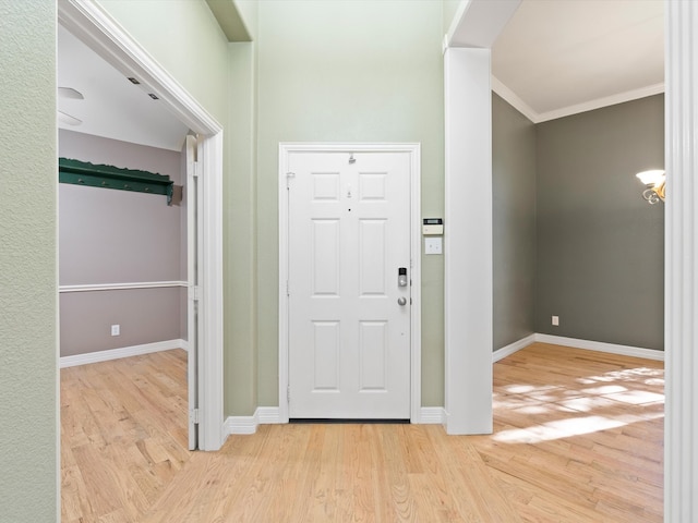 entryway featuring crown molding and light hardwood / wood-style floors