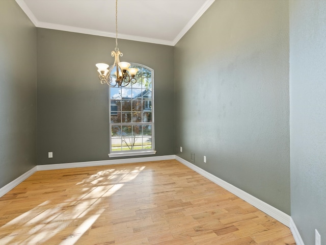 unfurnished dining area with light hardwood / wood-style flooring, a notable chandelier, and crown molding