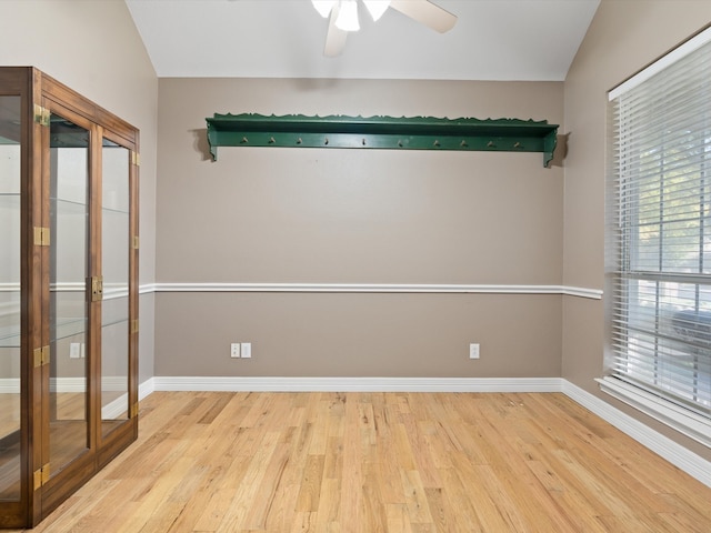 unfurnished room featuring ceiling fan, light hardwood / wood-style floors, lofted ceiling, and french doors