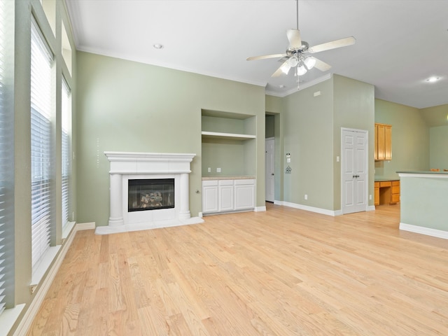 unfurnished living room featuring ceiling fan, built in features, light wood-type flooring, and ornamental molding