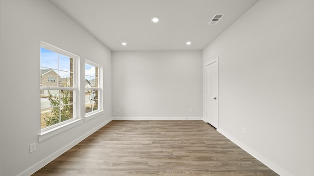 unfurnished room featuring hardwood / wood-style flooring