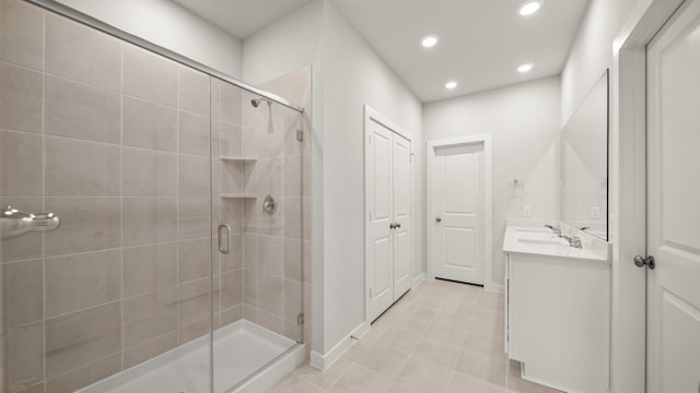 bathroom featuring vanity, an enclosed shower, and tile patterned floors