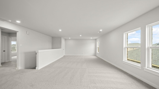 unfurnished room with light colored carpet