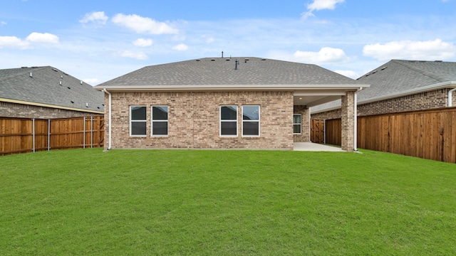 rear view of property featuring a yard and a patio