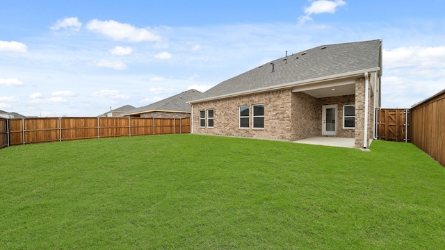 rear view of property featuring a patio area and a lawn