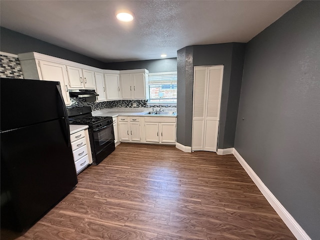 kitchen with white cabinets, sink, dark wood-type flooring, and black appliances