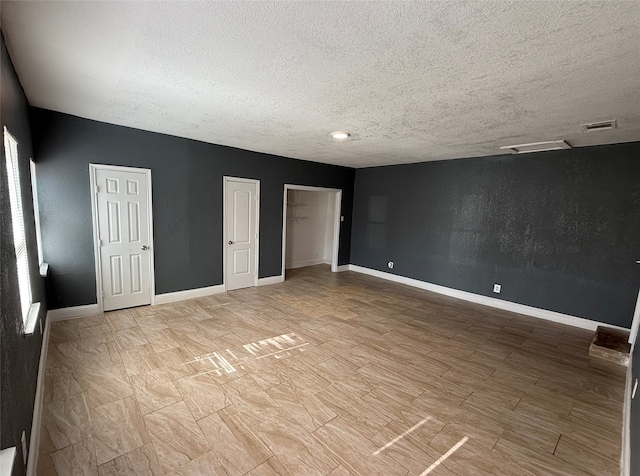 unfurnished bedroom with a textured ceiling