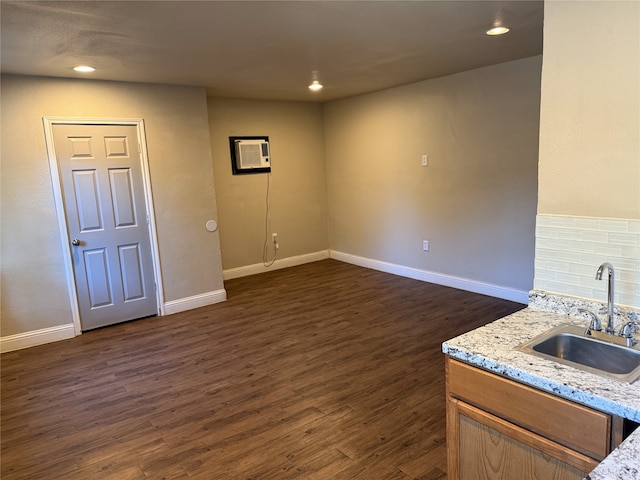 basement featuring dark hardwood / wood-style flooring and sink