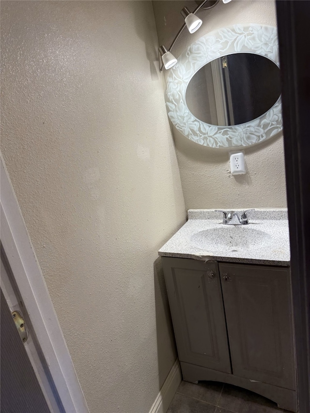 bathroom featuring tile patterned flooring and vanity