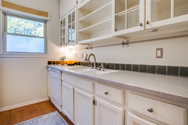 kitchen with dishwasher, white cabinetry, wood-type flooring, and sink