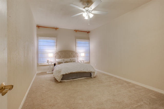 bedroom featuring ceiling fan and light carpet