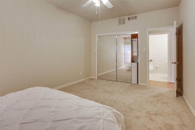 bedroom with a closet, light colored carpet, and ceiling fan