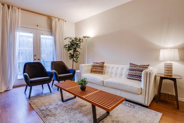 living room with hardwood / wood-style flooring and french doors