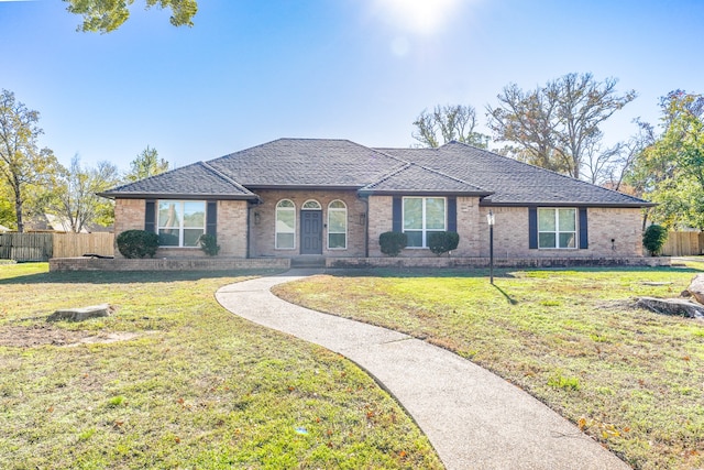 ranch-style home featuring a front yard