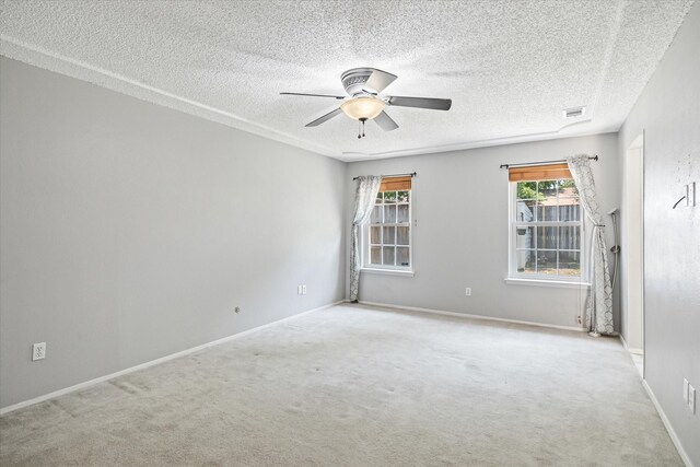 carpeted empty room featuring a textured ceiling and ceiling fan