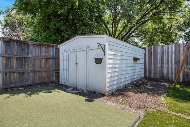 view of outbuilding with a lawn