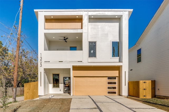 contemporary house with a balcony, a garage, and ceiling fan