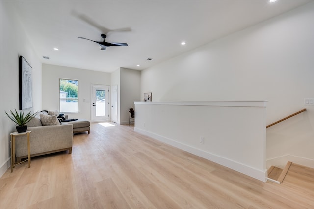 living room featuring light hardwood / wood-style flooring and ceiling fan