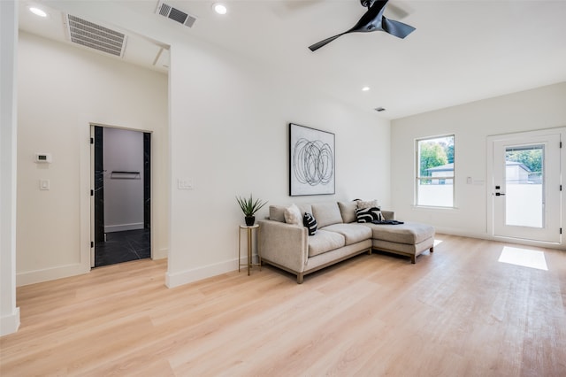 living room featuring light hardwood / wood-style flooring and ceiling fan