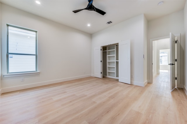 unfurnished bedroom with ceiling fan, light hardwood / wood-style floors, and a closet